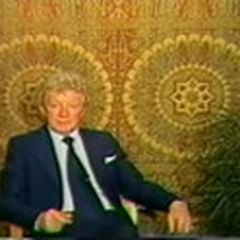Hans Jenny introducing the film, seated before two cymatic mandala patterns