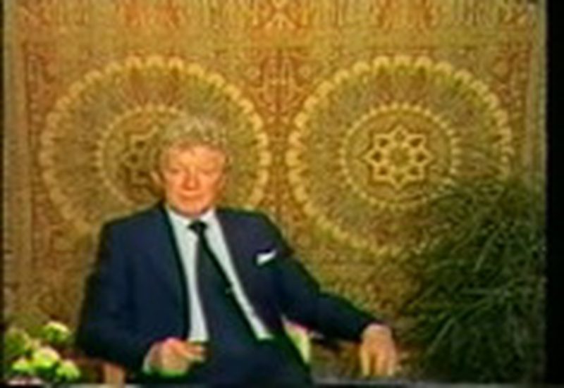 Hans Jenny introducing the film, seated before two cymatic mandala patterns