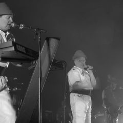 Devo performing live in their Energy Dome hats and yellow jumpsuits, 2009