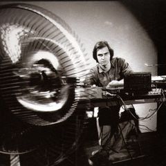 Ron Kuivila with a hand-held electric fan and live-electronics setup