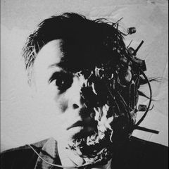 Still from Tetsuo: Iron Man — a face merging with metal