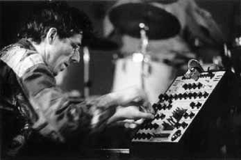 Thomas Lehn performing on his analog synthesizer, hands on the patch panel