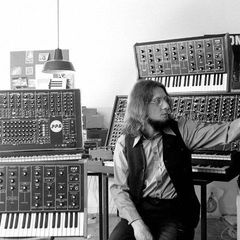 Wolfgang Palm seated among PPG synthesizers