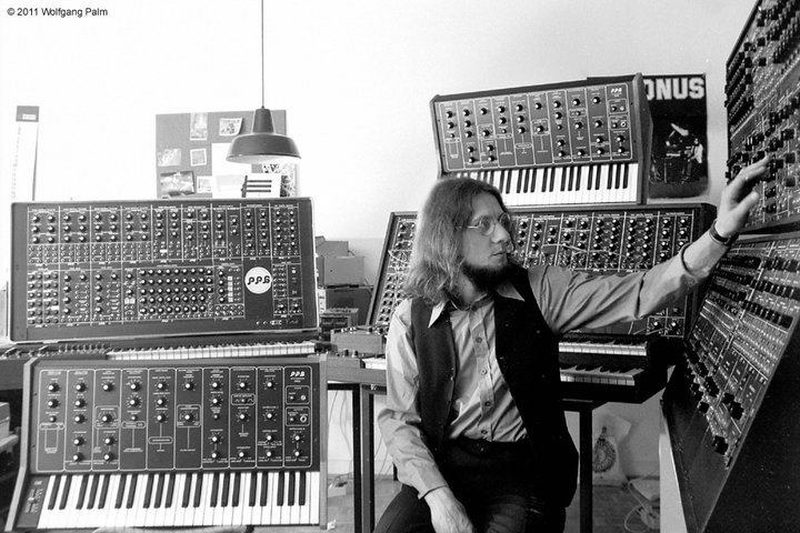 Wolfgang Palm seated among PPG synthesizers