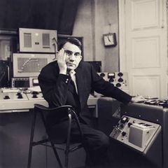Pierre Schaeffer seated at a studio console