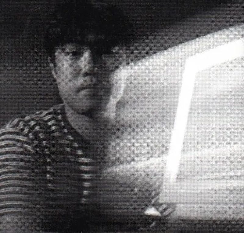 Tetsu Inoue lit by the glow of a monitor